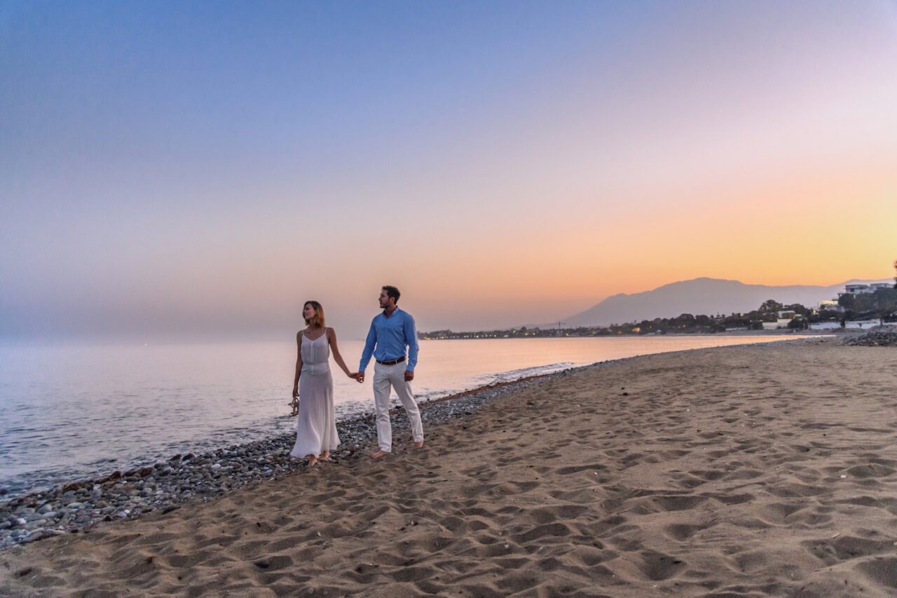 Parents holding hands on the beach